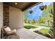 Inviting porch with comfortable seating and hanging plants, offering a relaxing view of the lush green landscape at 9603 Dunning Cir, Highlands Ranch, CO 80126