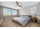 Serene main bedroom with decorative wallpaper, neutral bedding, ceiling fan, and ample natural light at 9603 Dunning Cir, Highlands Ranch, CO 80126