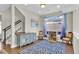 Bright living room featuring a staircase, hardwood floors, blue accents and a blue accent rug at 5028 S Addison Way, Aurora, CO 80016