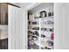 Organized walk-in pantry features white shelving and ample space for food and kitchen appliance storage at 5028 S Addison Way, Aurora, CO 80016