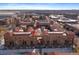Aerial view of townhome community with brick buildings, red roofs, and landscaped grounds showcasing community layout at 190 Roslyn St # 802, Denver, CO 80230