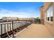 Balcony view with black iron railing and brown floor at 190 Roslyn St # 802, Denver, CO 80230