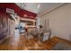 Dining area open to kitchen with stainless appliances and wood floors, blending cooking and dining creating a social ambiance at 190 Roslyn St # 802, Denver, CO 80230