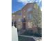Charming brick townhome with balcony and blooming tree, showcasing a well-maintained facade and welcoming entrance at 190 Roslyn St # 802, Denver, CO 80230