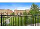Balcony view of a well-maintained community lawn, framed by townhomes and lush greenery, showcasing serenity at 190 Roslyn St # 802, Denver, CO 80230