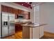 Modern kitchen featuring stainless steel appliances, granite countertops, and ample wooden cabinetry at 190 Roslyn St # 802, Denver, CO 80230