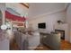 Open living room with vaulted ceiling, hardwood floors, fireplace, and view into the kitchen offering modern comfort at 190 Roslyn St # 802, Denver, CO 80230