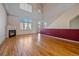Open living space featuring hardwood floors, a cozy fireplace, and large windows filling the room with natural light at 190 Roslyn St # 802, Denver, CO 80230