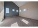 Unfurnished living room with vaulted ceiling and natural light, featuring multiple windows at 190 Roslyn St # 802, Denver, CO 80230