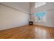 Bright living space with hardwood floors, fireplace, and large window offering natural light and inviting comfort at 190 Roslyn St # 802, Denver, CO 80230