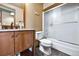 This bathroom features a single sink vanity, granite countertop, natural wood cabinets, and a shower at 4380 Sandstone Dr, Monument, CO 80132