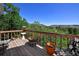 Relaxing deck area with wooden railings, outdoor seating, and stunning views of the surrounding landscape at 4380 Sandstone Dr, Monument, CO 80132