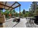 Spacious deck area with seating, grill and decorative plants offering serene outdoor living at 4380 Sandstone Dr, Monument, CO 80132
