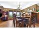 Bright dining room with large window views, wood floors, and modern chandelier at 4380 Sandstone Dr, Monument, CO 80132