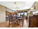 Dining room with views from windows, hardwood floors, and chandelier at 4380 Sandstone Dr, Monument, CO 80132