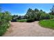 Wide driveway surrounded by lush greenery leading up to a charming home exterior at 4380 Sandstone Dr, Monument, CO 80132