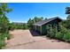 Two car garage with an exterior painted green and set back amongst mature trees at 4380 Sandstone Dr, Monument, CO 80132