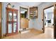Bright hallway featuring tile floors, built-in cabinets, and a charming Dutch door to laundry at 4380 Sandstone Dr, Monument, CO 80132