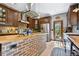 Well-lit kitchen with a butcher block island, stainless appliances, and tile floors at 4380 Sandstone Dr, Monument, CO 80132
