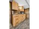 Bright kitchen featuring custom wood cabinets, stone backsplash, granite countertops, and modern appliances at 4380 Sandstone Dr, Monument, CO 80132