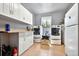 Laundry room with a folding counter, white cabinets, and a washer and dryer at 4380 Sandstone Dr, Monument, CO 80132