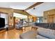 Spacious living room with wood floors and open floor plan leading to dining room and stairway at 4380 Sandstone Dr, Monument, CO 80132