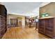Open living room showcasing wood floors and wooden furniture with access to dining area at 4380 Sandstone Dr, Monument, CO 80132