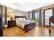 Bedroom with hardwood floors and a door to balcony with view at 4380 Sandstone Dr, Monument, CO 80132