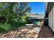 Outdoor seating on stone patio set amongst grass, trees, and rolling hills at 4380 Sandstone Dr, Monument, CO 80132