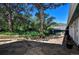 Stone patio featuring mature trees, lush plants, and outdoor seating area at 4380 Sandstone Dr, Monument, CO 80132