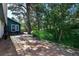 Stone patio featuring mature trees, lush plants, and outdoor seating area at 4380 Sandstone Dr, Monument, CO 80132