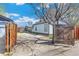 The backyard features driveway, partial fencing, and small patio with home access at 4401 Quieto Ct, Denver, CO 80211