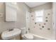 Bright bathroom featuring tiled walls with colorful accents and classic fixtures at 4401 Quieto Ct, Denver, CO 80211