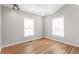 Bright bedroom featuring hardwood floors, two windows, and neutral paint scheme at 4401 Quieto Ct, Denver, CO 80211
