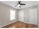 Bedroom featuring hardwood floors, ceiling fan, closet and bright window at 4401 Quieto Ct, Denver, CO 80211