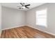Bedroom featuring hardwood floors, ceiling fan, and a bright window at 4401 Quieto Ct, Denver, CO 80211