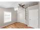 Bedroom featuring hardwood floors, closet, ceiling fan and ample natural light from a large window at 4401 Quieto Ct, Denver, CO 80211