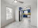 Bright dining area featuring patterned tile flooring and a view into the charming, colorful kitchen at 4401 Quieto Ct, Denver, CO 80211