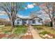 Charming single-story home with a tidy front yard and a inviting walkway under mature trees at 4401 Quieto Ct, Denver, CO 80211