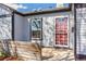 The front door is sheltered by a small porch with a decorative door and side window at 4401 Quieto Ct, Denver, CO 80211