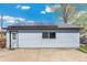Sleek garage featuring solar panels and a new door at 4401 Quieto Ct, Denver, CO 80211
