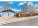 View of the detached two car garage and fenced backyard as seen from the street at 4401 Quieto Ct, Denver, CO 80211