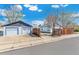 View of the detached two car garage and fenced backyard as seen from the street at 4401 Quieto Ct, Denver, CO 80211