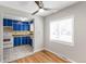 Bright eat-in kitchen with vintage blue cabinetry and an adjacent dining area at 4401 Quieto Ct, Denver, CO 80211