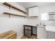 Kitchenette with mini-fridge, shelves, and stainless steel sink at 4401 Quieto Ct, Denver, CO 80211