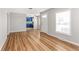 Bright living room featuring refinished hardwood floors and views into the kitchen at 4401 Quieto Ct, Denver, CO 80211