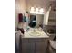 Bathroom with a vanity, mirror, and storage cabinet, offering functionality and a clean aesthetic at 604 S Xenon Ct, Lakewood, CO 80228