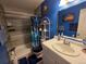 Bathroom with a shower-tub combo with blue shower curtain and coordinated blue towels and accessories at 604 S Xenon Ct, Lakewood, CO 80228