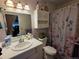 Bright bathroom with a decorative shower curtain, vanity, and medicine cabinet for storage at 604 S Xenon Ct, Lakewood, CO 80228