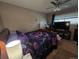 Comfortable bedroom features a ceiling fan and window with blinds, and a bed with a butterfly comforter at 604 S Xenon Ct, Lakewood, CO 80228